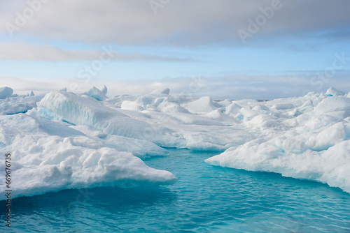 Melting ice at the edge of the ice pack in the arctic ocean, ice bergs floating in the ocean in the far north, signs of global warming and climate change  © knelson20