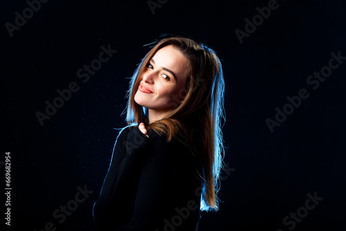 A woman in a black shirt is posing for a picture. A Captivating Portrait of a Stylish Woman in a Black Shirt
