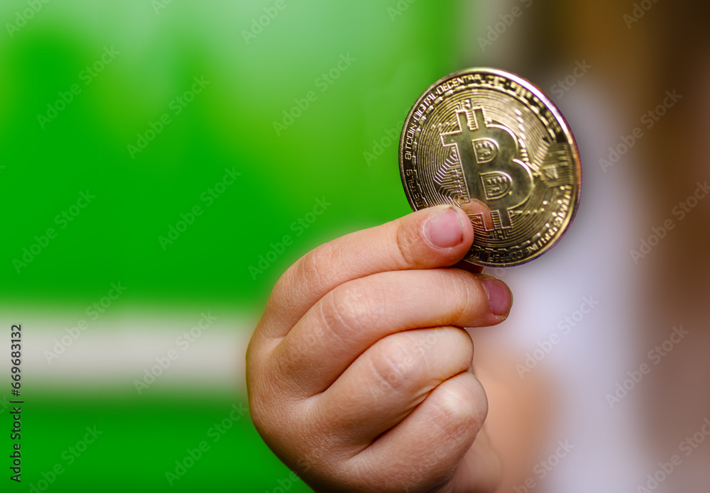 Bitcoin in a child's hand, thematic background for crypto news Bitcoin in a child's hand, thematic background for crypto news
