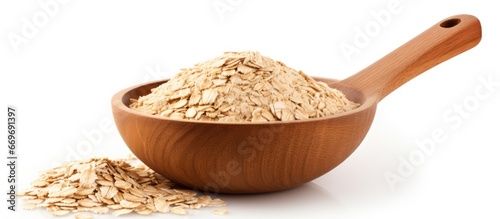 Isolated white bowl with oat flakes and wooden spoon