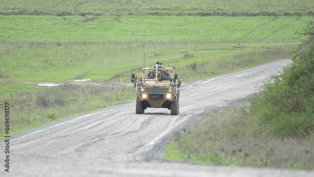 British army Supacat Jackal rapid assault and reconnaissance vehicle in action, military battle exercise British army Supacat Jackal rapid assault and reconnaissance vehicle in action, military battle exercise