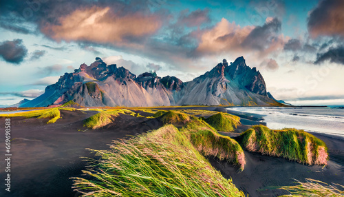 Majestic summer scene of Stokksnes headland with Vestrahorn (Batman Mountain) on background. Unbelievable evening view of Iceland, Europe. Beauty of nature concept background photo