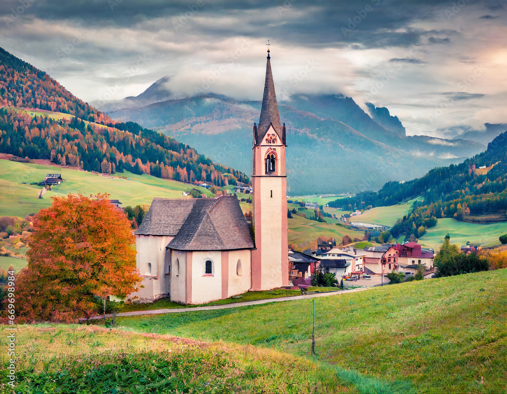 Astonishing autumn view of San Genesio and Santa Barbara churches. Gloomy morning scene of Tolpei village, Province of Bolzano - South Tyrol, Italy. Beauty of countryside concept background