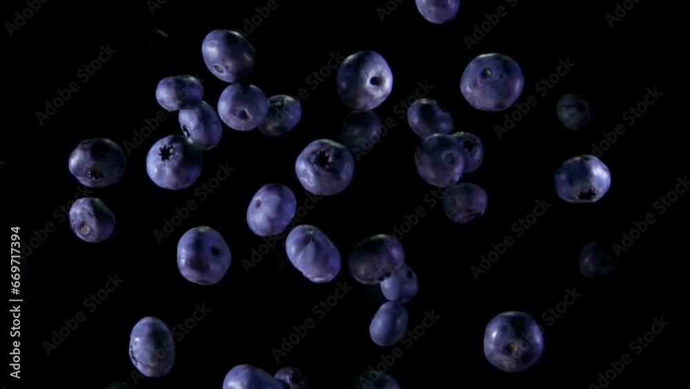 Large juicy delicious blueberries are bouncing up with splashes of the water Large juicy delicious blueberries are bouncing up with splashes of the water