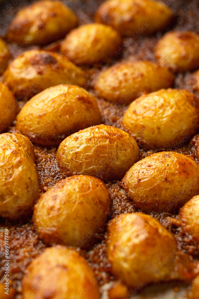 Parmesan crusted baby new potatoes on a baking tray Parmesan crusted baby new potatoes on a baking tray