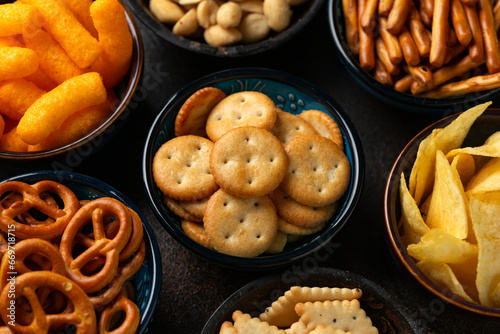 Salty snacks crackers, potato chips, pretzel, peanuts, corn puffs.