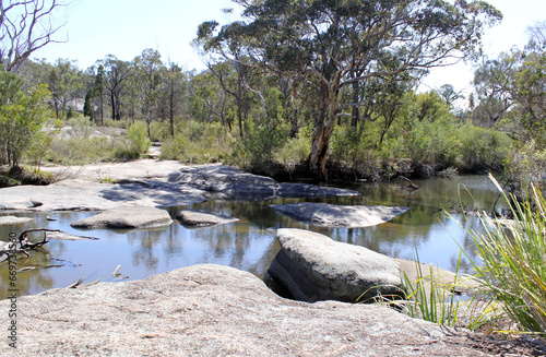 Creek with water, trees and rocks at Girraween National Park in Queensland, Australia photo