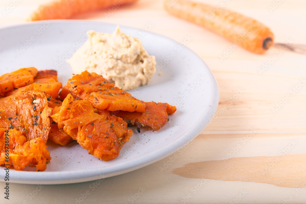 Baked carrot chips and chickpea hummus. Tasty vegan snack idea. Baked carrot chips and chickpea hummus. Tasty vegan snack idea.