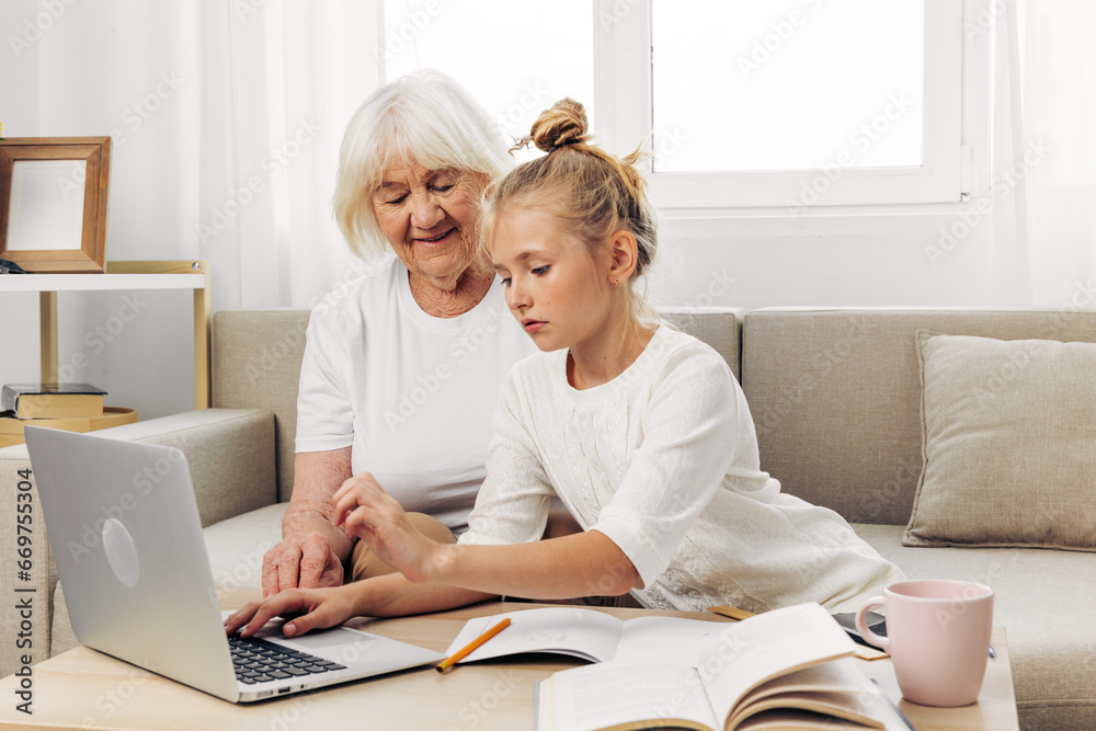 Child grandmother selfie hugging bonding granddaughter family sofa laptop smiling togetherness