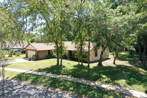 Aerial view of suburban ranch house among trees, Daytona Beach, Florida.