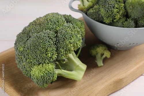 Fresh raw broccoli on white wooden table, closeup