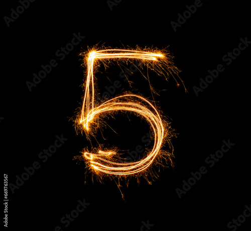 Fireworks numbers 5 Burning sparkler Numbers isolated on black background. Sparkler firework light alphabet 5 and number five. Numbers Alphabet of Sparklers photo