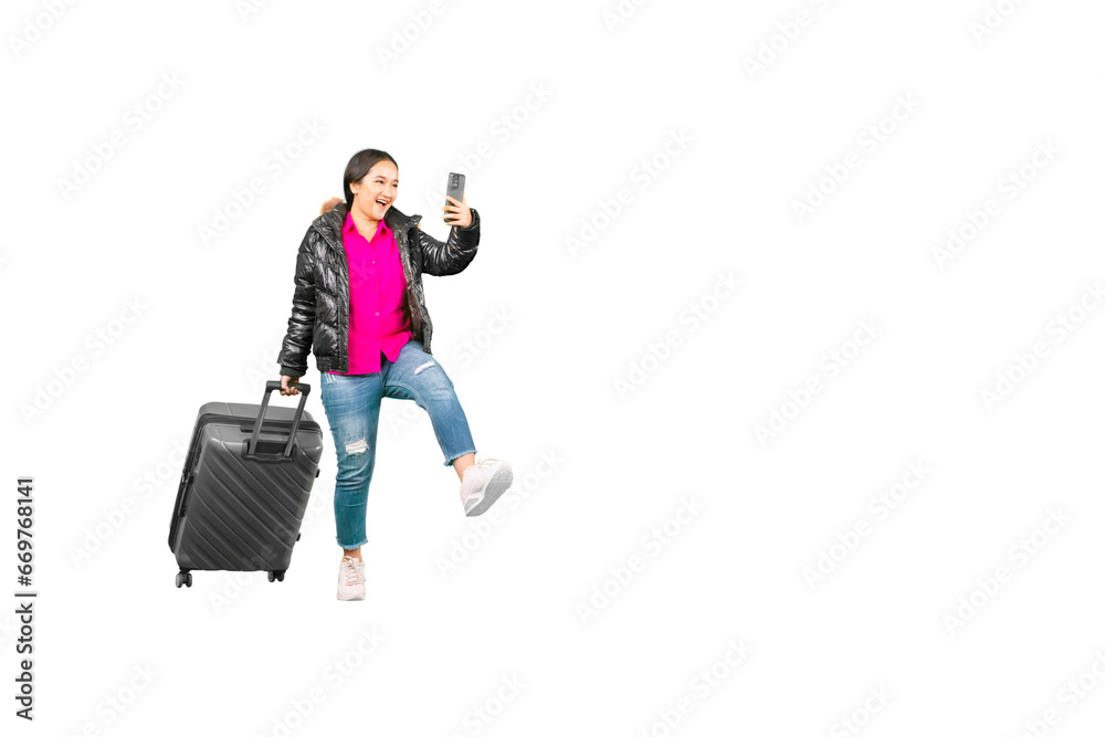 Full length body size of a happy asian woman walking with a suitcase while taking a self portrait Full length body size of a happy asian woman walking with a suitcase while taking a self portrait