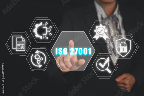 ISO 27001 concept, Businesswoman hand touching ISO 27001 icon on virtual screen.