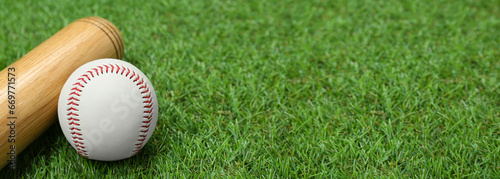 Photography Baseball bat and ball on green grass, space for text