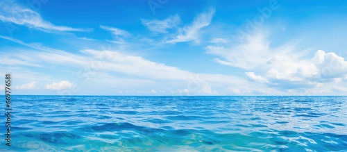 Blue sea and cloudy blue sky image © AkuAku
