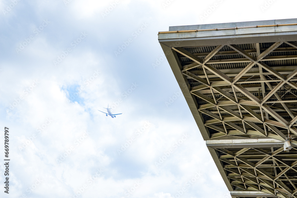 Civil aviation aircraft flying over modern buildings in the city Civil aviation aircraft flying over modern buildings in the city