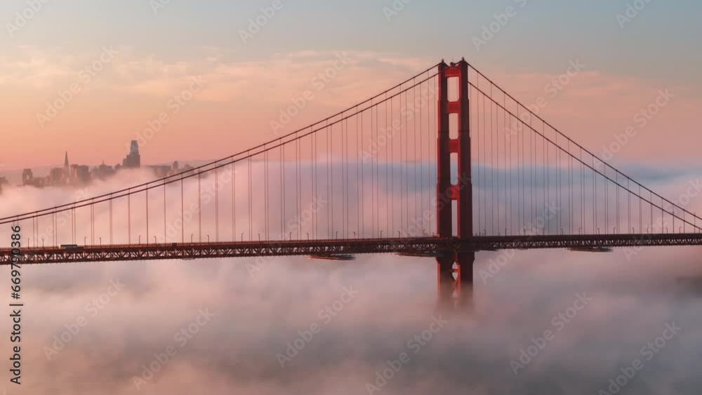 Epic landscape with cinematic pink clouds floating around scenic red Golden Gate bridge with San Francisco cityscape on motion background. Breathtaking views on major USA landscape. Tourism background Epic landscape with cinematic pink clouds floating around scenic red Golden Gate bridge with San Francisco cityscape on motion background. Breathtaking views on major USA landscape. Tourism background