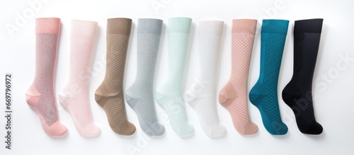 Compression hosiery for varicose veins and venous therapy including medical stockings socks and sleeves as well as clinical knits and sports socks on white background photo
