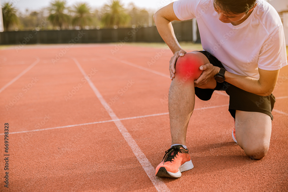 Fototapeta premium Fit man runner has twisted ankle injury while practice marathon run at the racetrack.