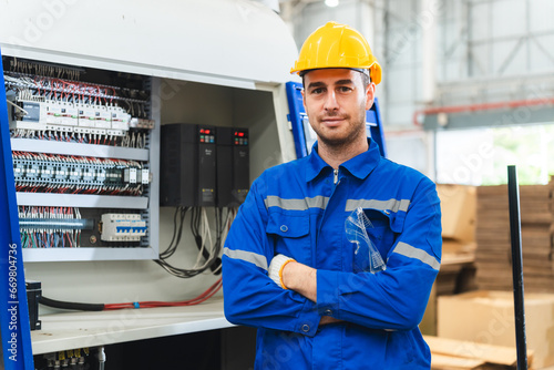 Professional male caucasian engineer or manufacturing worker man person in factory portrait, smart industry business manager occupation job with safety helmet for construction work, machinery foreman