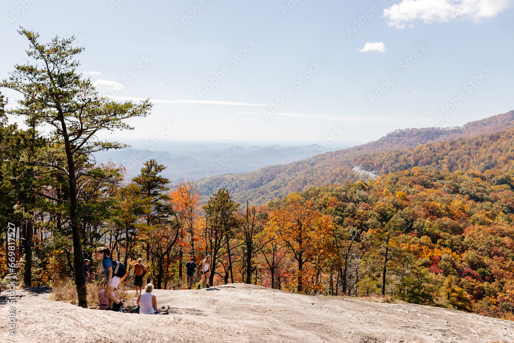 Beautiful autumn mountain landscape from a bird's eye view on sunny day.Mountains covered with trees in autumn with red, orange leaves. Autumn in the forest. Table Rock, Great Smokey Mountain, SC, USA