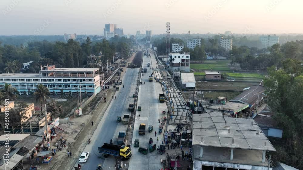 Aerial journey along the Dhaka-Rangpur Highway in Bogra, Bangladesh. Seamless fusion of urban and rural landscapes. Aerial journey along the Dhaka-Rangpur Highway in Bogra, Bangladesh. Seamless fusion of urban and rural landscapes.