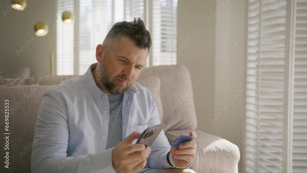 Happy guy buying online and throwing card up in air. Male customer making purchase on smartphone. Smiling mature handsome man indoors holding credit card paying online order using mobile banking app Happy guy buying online and throwing card up in air. Male customer making purchase on smartphone. Smiling mature handsome man indoors holding credit card paying online order using mobile banking app