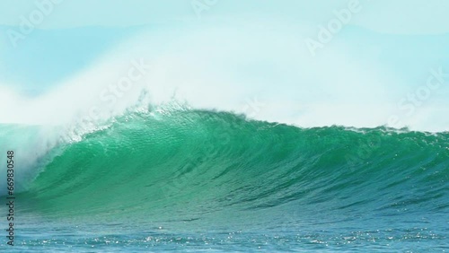 Cinematic slow-motion stunning aqua blue huge wave surf barrel swell wind froth Hossegor Seignosse Biarittz Basque Country European holiday destination WSL ocean tide stunning summer day pan follow photo