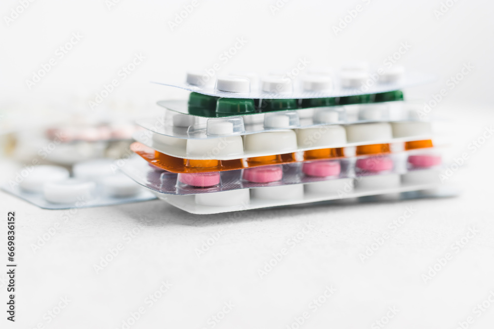 Pile of various pills and tablets in a blister pack on white background, healthcare and medicine concept Pile of various pills and tablets in a blister pack on white background, healthcare and medicine concept