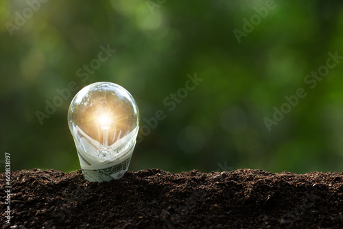Renewable Energy.Environmental protection, renewable, sustainable energy sources. A banknote wrapped a light bulb represents Renewable energy is important to the world. saving energy, saving money