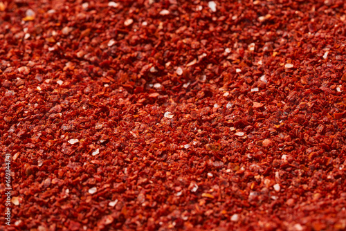close up dry red pepper flake powder coarse. Korean chili ground Gochugaru texture background. Korean red pepper flake powder coarse ground gochugaru.