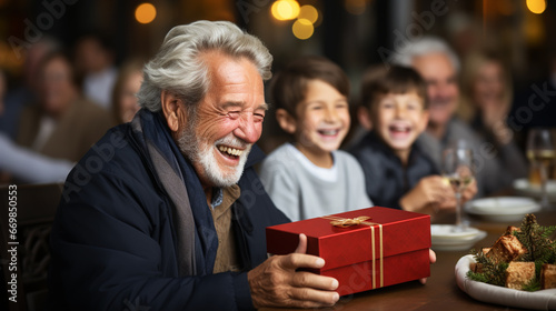 Happy mature grandparent with gift box with present from grandchild