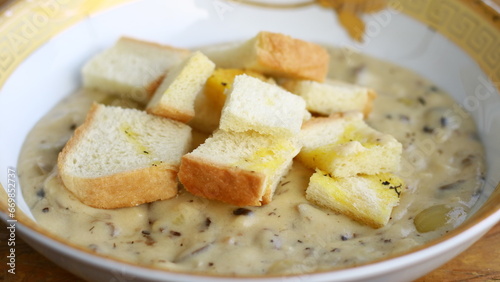 Creamy soup topped with slices of bread.