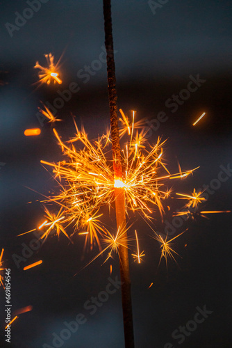 Fototapeta Naklejka Na Ścianę i Meble -  Many sharp sparks in the form of stars from sparklers close-up