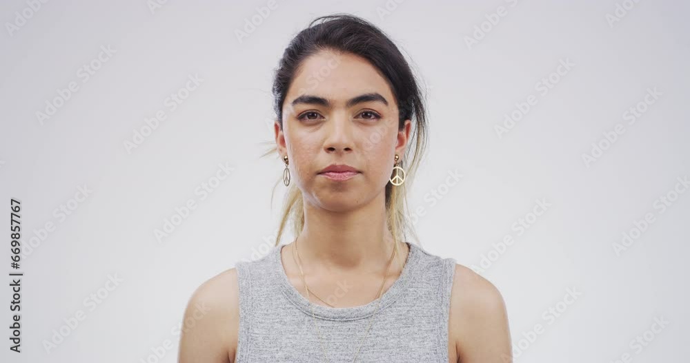 Serious woman, face and blank stare standing isolated against a studio background. Portrait of attractive caucasian female person or casual model looking with no facial expression on mockup space