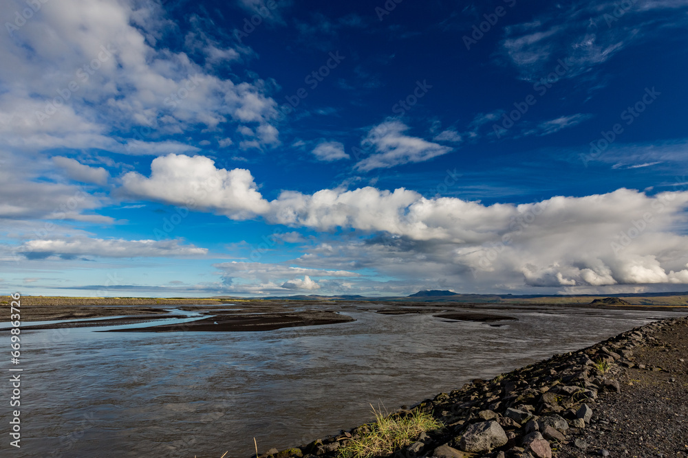 Scenery sky with clouds over the broad river, Southern Iceland, travel photograph taken from one bridge Scenery sky with clouds over the broad river, Southern Iceland, travel photograph taken from one bridge