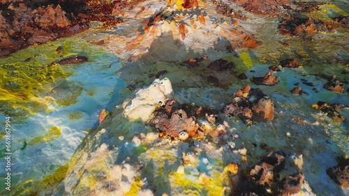 Dallol volcano, Danakil Depression, Ethiopia. Top down aerial view. Colorful sulfur ponds at sunrise. Cinematic drone footage of incredible natural valley. Famous travel destination landmark.