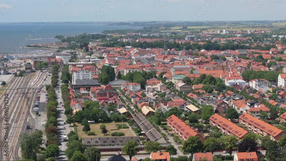 City Ystad skyline with orange rooftops and railroad station, aerial sideways City Ystad skyline with orange rooftops and railroad station, aerial sideways