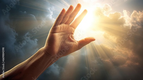 A man's hand reaches for the light in the clouds