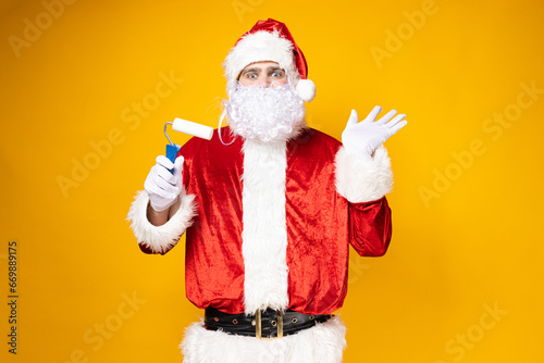 Santa Claus makes repairs on a yellow background.