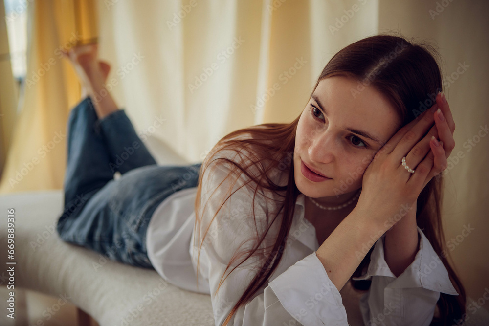 Young beautiful girl in white shirt and blue jeans Young beautiful girl in white shirt and blue jeans