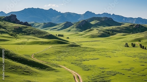 Panoramic view of an alpine mountain range with a green valley in the foreground