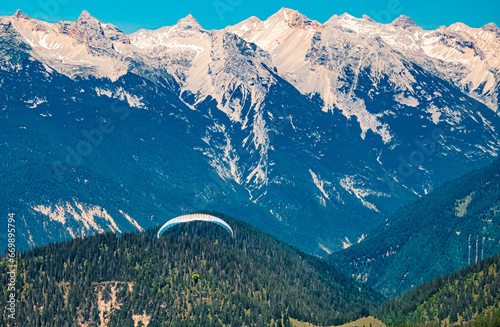 Alpine summer view with a paraglider at Mount Seefelder Joch, Rosshuette, Seefeld, Tyrol, Austria