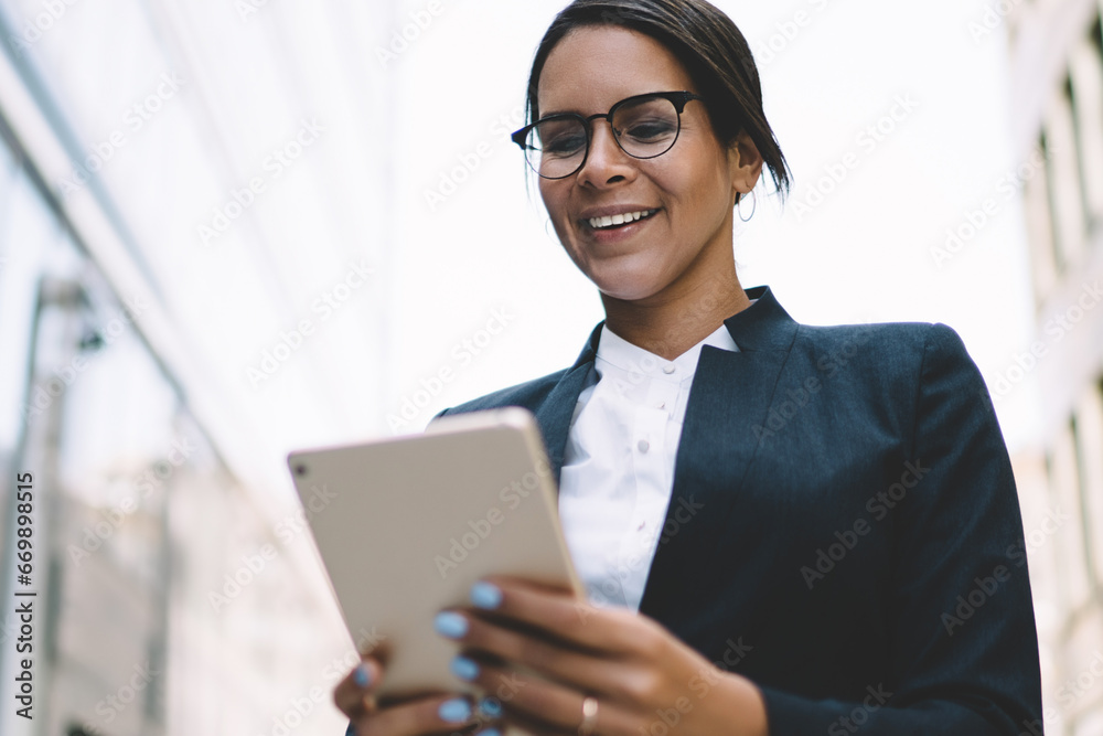 happy businesswoman in stylish eyewear reading news in company chat happy businesswoman in stylish eyewear reading news in company chat