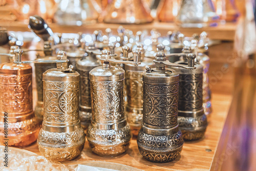 Fototapeta Naklejka Na Ścianę i Meble -  Traditional Turkish copper ornated pepper mills. Close up, souvenir from Turkey (Turkiye)
