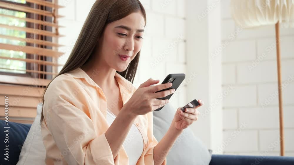 Woman using phone with credit card for ecommerce, online shopping or bank app in house living room or home sofa. Smile, happy and relax customer on fintech technology or mobile banking retail software