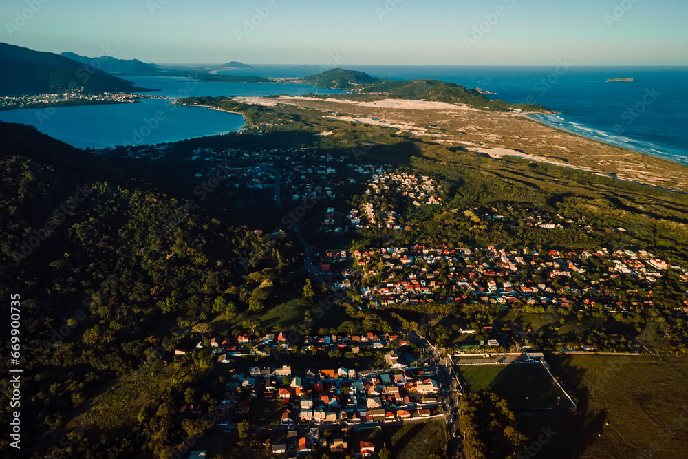 Coastline with ocean and town with sunset tones in Campeche, Florianopolis