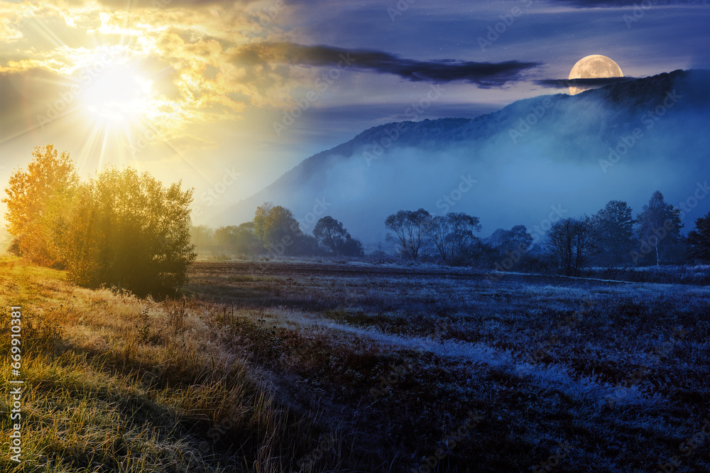 Fototapeta premium morning fog among trees on meadow in mountains with sun and moon at twilight in autumn. day and night time change concept. mysterious countryside scenery in morning light