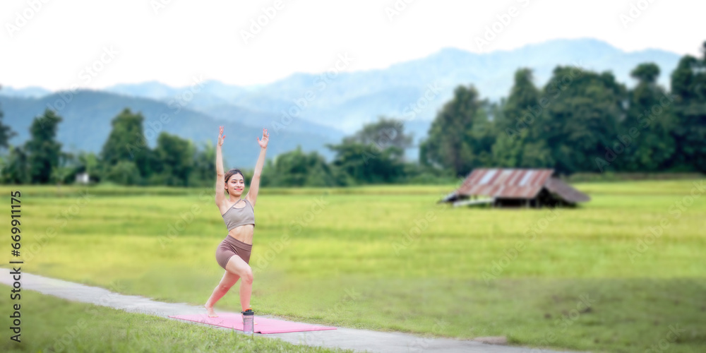 Healthy women doing yoga in the morning In the middle of a rice field . concept healthy and outdoor activity